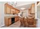 Eat-in kitchen with a chandelier, wood cabinets, and updated flooring at 2274 Old Wilkesboro Rd, Statesville, NC 28625