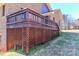 A view of the back deck which is made of wood with dark stained rails and latticework underneath at 2274 Old Wilkesboro Rd, Statesville, NC 28625