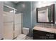 Bathroom featuring a vanity with granite countertop and framed mirror, toilet and shower with glass door at 228 Black Mountain Dr, Fort Mill, SC 29708