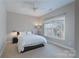 Minimalist bedroom with a plush bed, soft carpet, and a large window offering natural light at 228 Black Mountain Dr, Fort Mill, SC 29708