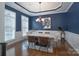 Dining room featuring hardwood floors, navy blue walls, modern table, and chandelier at 228 Black Mountain Dr, Fort Mill, SC 29708