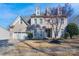 Charming two-story home with brick facade, dormer windows, three car garage and manicured front yard at 228 Black Mountain Dr, Fort Mill, SC 29708