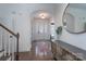 Elegant foyer with hardwood floors, wainscoting, large round mirror and lots of light at 228 Black Mountain Dr, Fort Mill, SC 29708