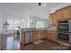 Open kitchen with stainless steel appliances, granite counters and breakfast bar overlooking the nook at 228 Black Mountain Dr, Fort Mill, SC 29708