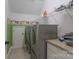 Functional laundry room with modern washer and dryer and storage shelves to keep everything organized at 228 Black Mountain Dr, Fort Mill, SC 29708