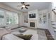Living room with fireplace, built-in shelving, and large windows overlooking the yard at 228 Black Mountain Dr, Fort Mill, SC 29708