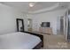 Spacious primary bedroom with a tray ceiling, neutral tones, and ensuite bathroom at 228 Black Mountain Dr, Fort Mill, SC 29708