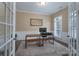 Bright office with french doors, natural light from the shuttered windows and modern desk at 228 Black Mountain Dr, Fort Mill, SC 29708