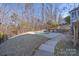 Backyard oasis with in-ground pool surrounded by mature trees and landscaped yard at 228 Black Mountain Dr, Fort Mill, SC 29708