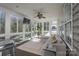 Bright sunroom featuring large windows, a ceiling fan, and cozy seating with a view of the backyard at 228 Black Mountain Dr, Fort Mill, SC 29708