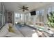 Sunroom with large windows, ceiling fan, and comfortable seating overlooking the patio and pool at 228 Black Mountain Dr, Fort Mill, SC 29708