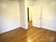 Hardwood floored bedroom featuring an open doorway at 2430 Mt Holly Huntersville Rd, Charlotte, NC 28214