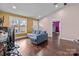 Bright living room with hardwood floors, colorful accent walls, and a comfortable blue sectional sofa at 245 North Dale Ave, Kannapolis, NC 28081