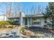 Inviting one-story home with a stone walkway and lush front yard landscaping at 2501 Tanglewood Ln, Charlotte, NC 28211