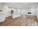 Well-lit kitchen area with stainless steel appliances, center island and wood floors, open to a spacious living room at 295 Bezelle Ave, York, SC 29745