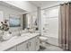 Bathroom featuring a vanity with quartz counters, framed mirror, and tub/shower combination at 298 Bezelle Ave, York, SC 29745