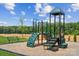 Community playground with green play structure, slide, and bench seating at 298 Bezelle Ave, York, SC 29745