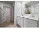Modern bathroom with double vanity, white cabinets and a large mirror with lots of counter space at 302 Bezelle Ave, York, SC 29745