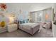 Charming bedroom with floral wallpaper, a plush bed, and a cozy reading nook by a bright window at 302 Bezelle Ave, York, SC 29745