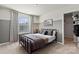 Stylish bedroom with a black metal bed frame, neutral decor, and a bright window with gray curtains at 302 Bezelle Ave, York, SC 29745