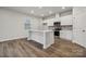 Bright kitchen with stainless steel appliances, white cabinets and island with countertop seating at 302 Bezelle Ave, York, SC 29745