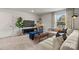 Inviting living room with a large sectional sofa, blue ottomans, neutral decor and a bright window at 302 Bezelle Ave, York, SC 29745
