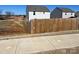 View of neighborhood houses behind a wooden privacy fence at 329 Aniston Ln, Shelby, NC 28152