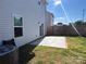 A spacious backyard features a concrete patio and a wooden fence, perfect for outdoor activities at 329 Aniston Ln, Shelby, NC 28152