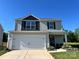 Charming two-story home boasts a two-car garage, covered porch, and lovely curb appeal at 329 Aniston Ln, Shelby, NC 28152