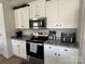 Kitchen with white cabinets, granite counters, and stainless steel microwave at 329 Aniston Ln, Shelby, NC 28152