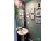 Fun powder room with pedestal sink and artistic wallpaper at 329 Aniston Ln, Shelby, NC 28152