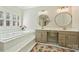 Bright bathroom with soaking tub, plantation shutters, and dual vanity at 4219 Kronos Pl, Charlotte, NC 28210