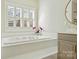 Bright bathroom with soaking tub, plantation shutters, and gold fixtures at 4219 Kronos Pl, Charlotte, NC 28210