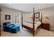 Cozy bedroom featuring a four-poster bed, plush chair, and natural light from the window at 4219 Kronos Pl, Charlotte, NC 28210