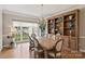 Formal dining room featuring a large wooden table, elegant chairs, built-in shelving, and a chandelier at 4219 Kronos Pl, Charlotte, NC 28210