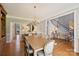 Elegant dining room with hardwood floors, a large wooden table, and a chandelier, perfect for entertaining at 4219 Kronos Pl, Charlotte, NC 28210