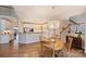 Eat-in kitchen and dining area with light wood floors and a statement chandelier for elegant dinners at 4219 Kronos Pl, Charlotte, NC 28210