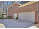 Spacious three-car garage with a brick exterior and well-maintained driveway at 4219 Kronos Pl, Charlotte, NC 28210