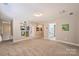 Spacious hallway with carpet flooring and walls decorated with colorful art prints at 4219 Kronos Pl, Charlotte, NC 28210