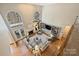 Sun-filled living room boasts soaring ceilings, fireplace, built-ins, hardwood floors and backyard views at 4219 Kronos Pl, Charlotte, NC 28210