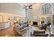 Grand living room with high ceilings, large arched windows, a fireplace, and comfortable seating at 4219 Kronos Pl, Charlotte, NC 28210