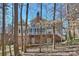 The rear exterior features a brick facade, a screened-in porch, and a wooden deck at 4219 Kronos Pl, Charlotte, NC 28210