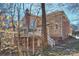 The rear exterior showcases a brick and beige facade, a chimney, and a wooden deck at 4219 Kronos Pl, Charlotte, NC 28210