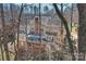 A high angle shows the rear exterior with a screened porch, deck, and mature trees at 4219 Kronos Pl, Charlotte, NC 28210