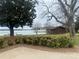Backyard view with mature trees, lake access, and a small storage shed at 4220 Honeysuckle Rd, Rock Hill, SC 29732