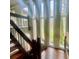 Staircase with wood steps and railing, adjacent to tall windows at 4220 Honeysuckle Rd, Rock Hill, SC 29732