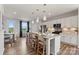 Kitchen island with stone countertop, stylish pendant lighting, and seating, open to dining area at 4407 Reed Creek Dr, Sherrills Ford, NC 28673