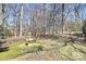 Exterior view of a brick path in the yard leading to a water fountain among bare trees and foliage at 4607 Carmel Vista Ln, Charlotte, NC 28226