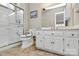 Well-lit bathroom with a walk-in shower and a white vanity with ample storage at 4607 Carmel Vista Ln, Charlotte, NC 28226