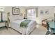 Serene bedroom featuring a queen bed with white bedding and a cozy sitting area near the window at 4607 Carmel Vista Ln, Charlotte, NC 28226